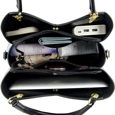 Felina™ – Elegant svart skulderveske med stilige anheng